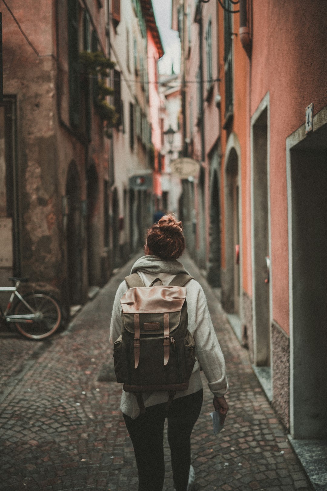 services-03 woman-walking-on-street-surrounded-by-buildings-iubgeneyvy8